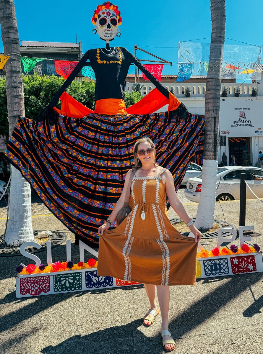 Travels Between With Colleen posing with a Catrina on the Malecón in Puerto Vallarta, Mexico