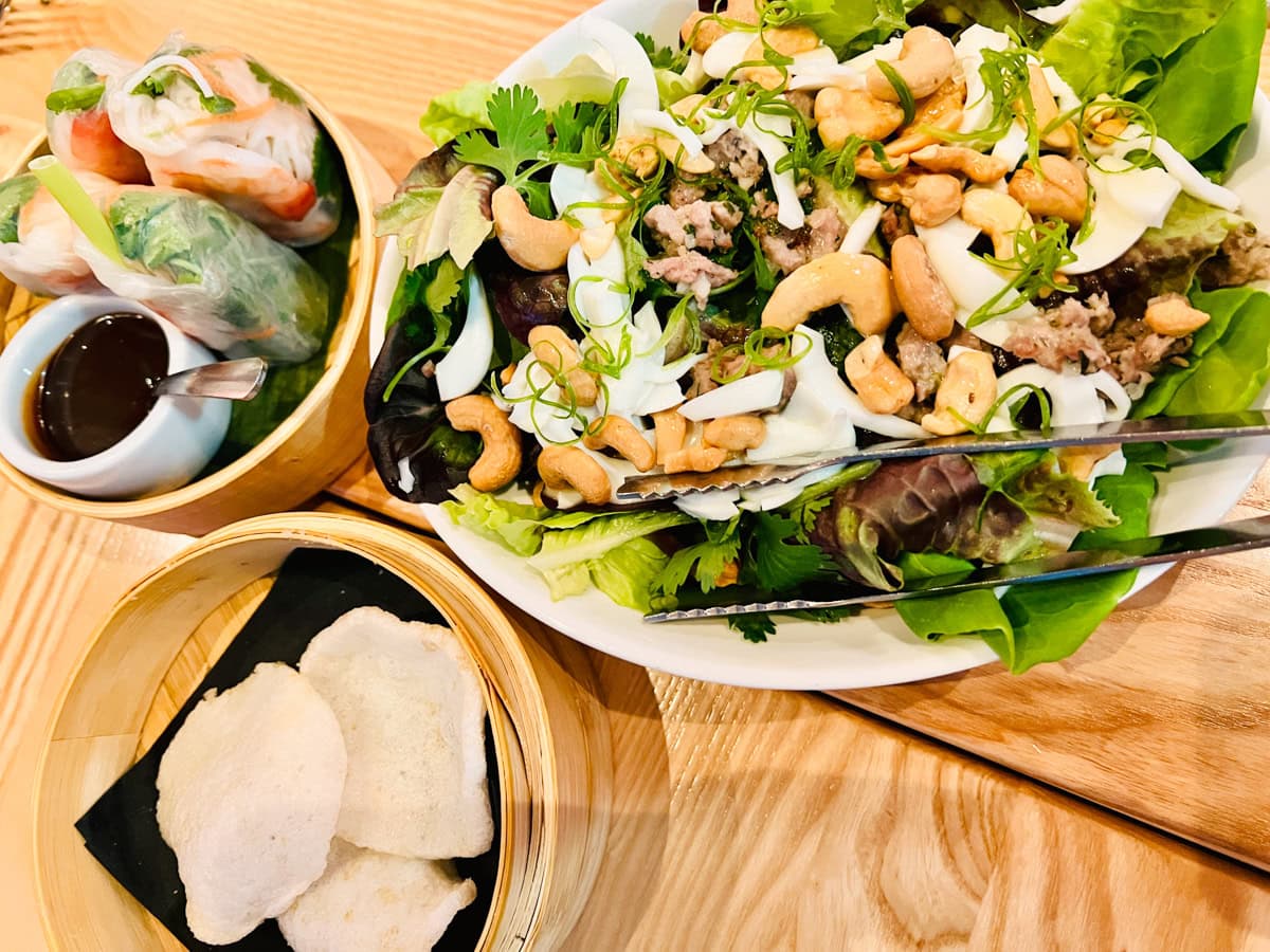 Summer rolls, complimentary crackers, and larb salad at SAAP in Cary 