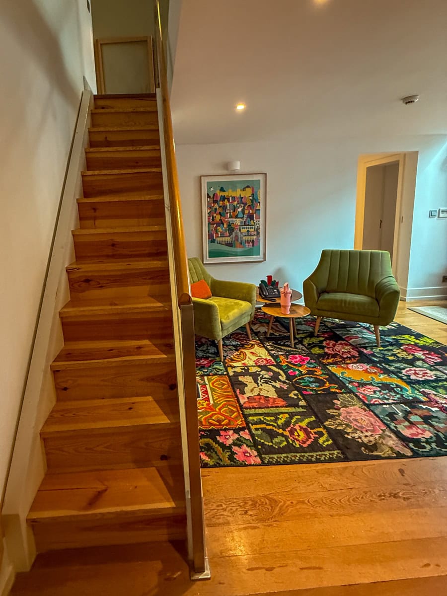 Stairs with safety gate leading to a second bedroom at Martinhal Chiado
