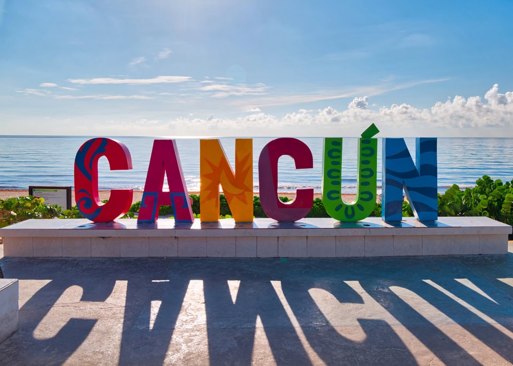 Pose by the Cancún sign at Playa Delfines