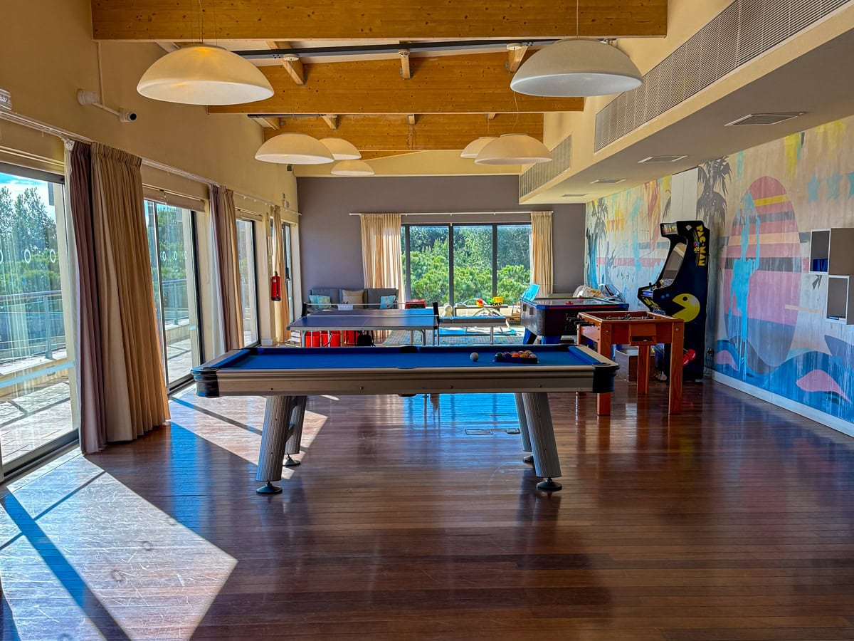 Blue Room hangout area for kids and teens with pool table, ping pong, foosball, and video games at Martinhal Sagres