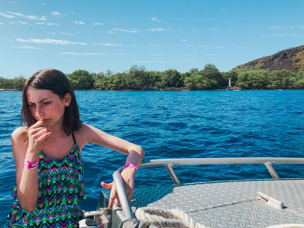 Young teen sporting Sea-Bands and powering through a rough catamaran ride in Hawaii 