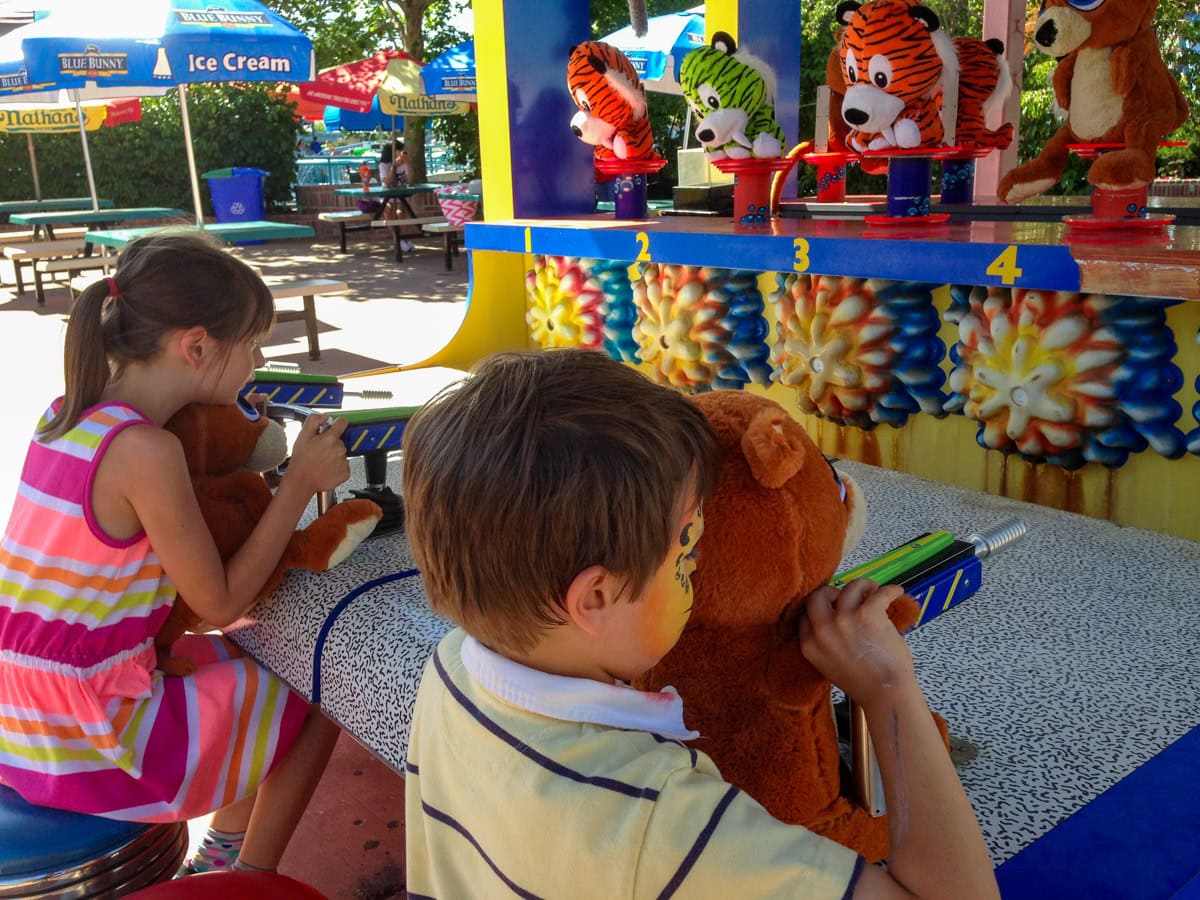 Kids playing a carnival game at Elitch Gardens 