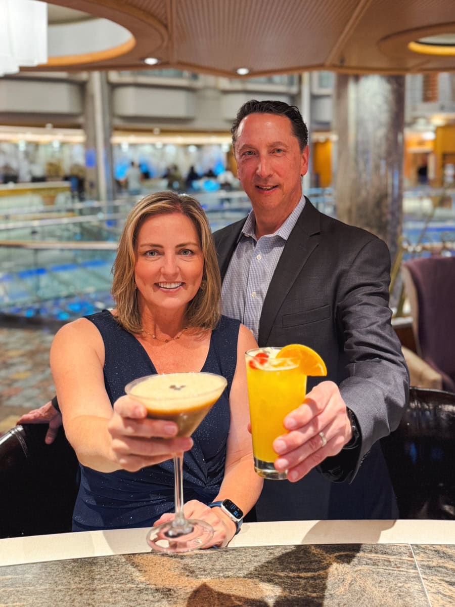 Couple holding Royal Caribbean mocktails, the Espresso No‑Tini and the Mai Spice