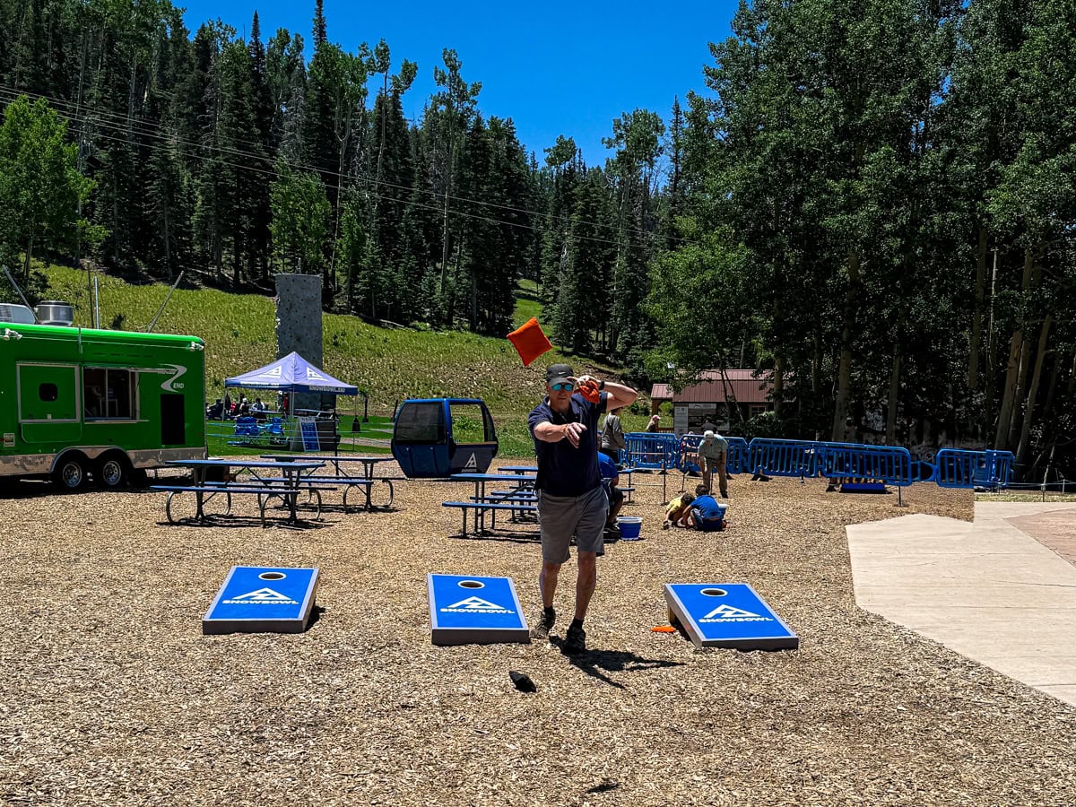 My husband playing cornhole at Agassiz Base Area