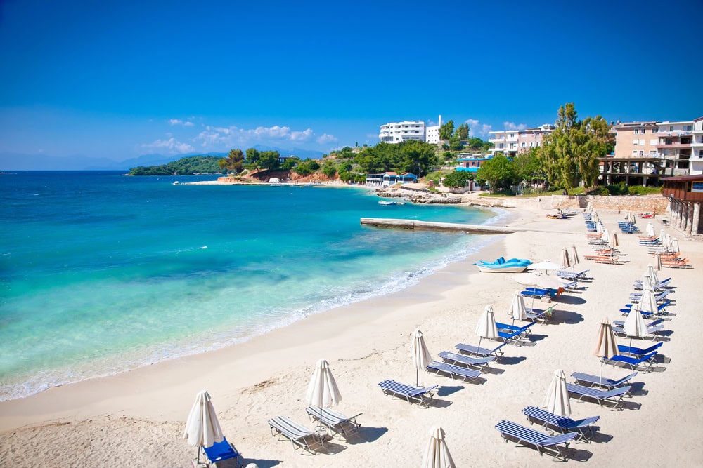 Beach loungers and umbrellas on the beach in Ksamil in the Albanian Riviera