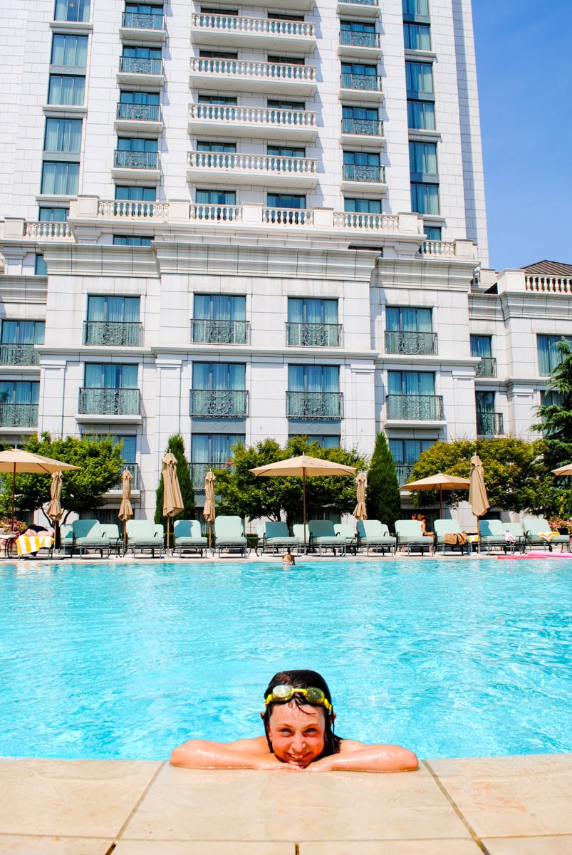 Kid swimming in The Grand America Hotel courtyard pool